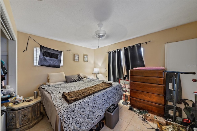 bedroom featuring light tile patterned flooring, a textured ceiling, and a ceiling fan