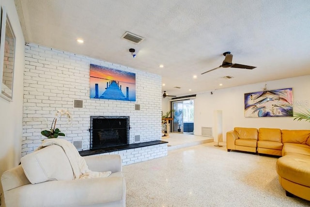552 Juan Anasco Dr, Longboat Key, FL 34228 - living area with speckle patterned floor, a brick fireplace, ceiling fan, and recessed lighting