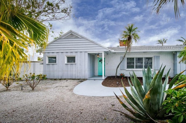 552 Juan Anasco Dr, Longboat Key, FL 34228 - view of front facade with brick siding and a chimney