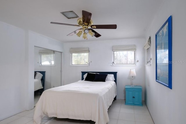552 Juan Anasco Dr, Longboat Key, FL 34228 - bedroom with multiple windows, light tile patterned floors, ceiling fan, and a closet