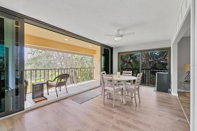 sunroom featuring ceiling fan