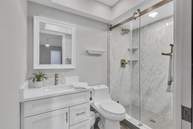 full bath with toilet, a stall shower, and vanity