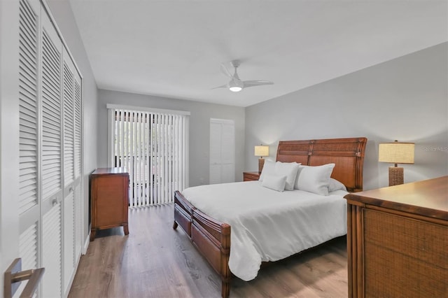bedroom with a closet, a ceiling fan, and wood finished floors