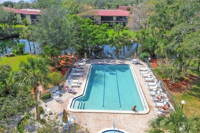 pool with a patio area and a water view