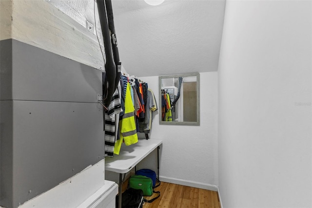 interior space with baseboards and wood finished floors