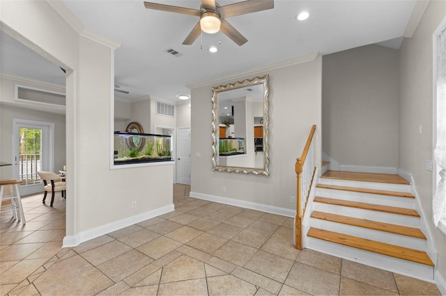 stairway with baseboards, ceiling fan, visible vents, and crown molding