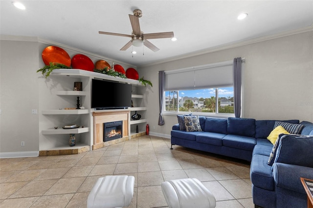 living area with light tile patterned floors, baseboards, a ceiling fan, ornamental molding, and recessed lighting