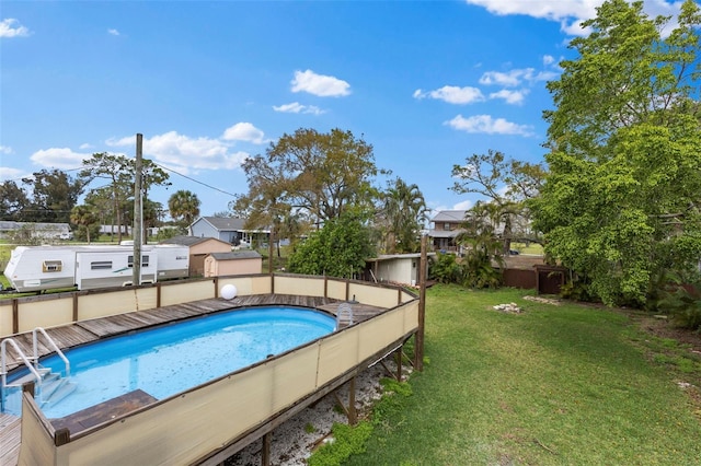 outdoor pool with a lawn and fence