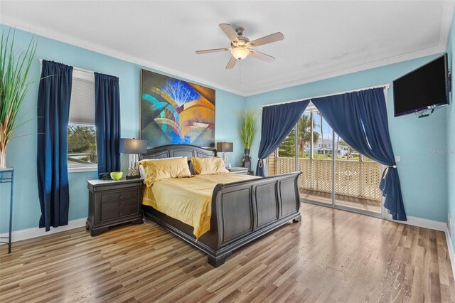 bedroom with access to exterior, crown molding, baseboards, and wood finished floors