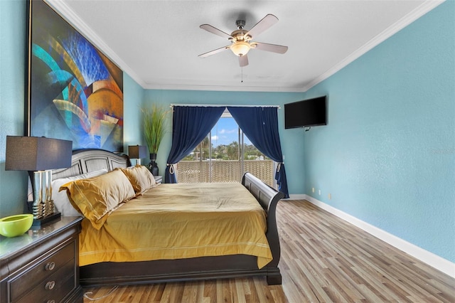 bedroom with baseboards, ceiling fan, wood finished floors, and crown molding