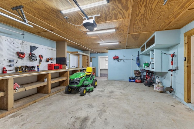 garage with a garage door opener and a workshop area