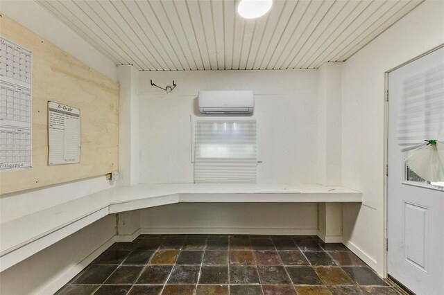 interior space featuring a wall mounted AC and wooden ceiling