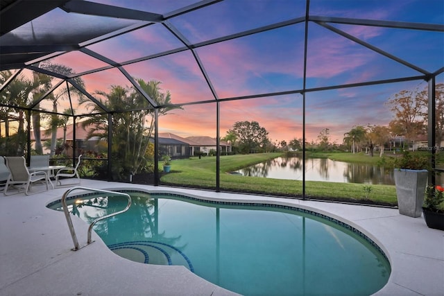 pool at dusk with a water view, a patio area, a lanai, and an outdoor pool