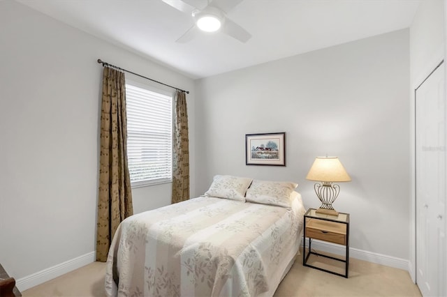 bedroom with baseboards, a ceiling fan, and light colored carpet