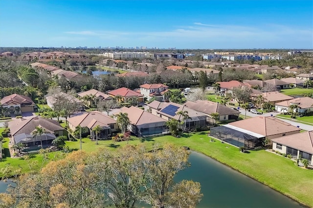 birds eye view of property with a water view and a residential view