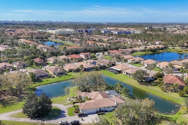 drone / aerial view featuring a water view and a residential view