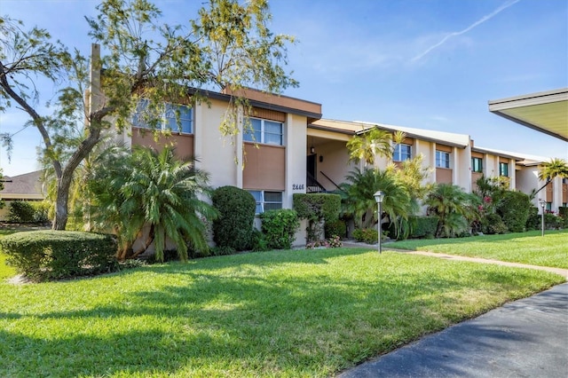 2446 Clubhouse Cir Unit 202, Sarasota, FL 34232 - view of front of home featuring stucco siding and a front yard