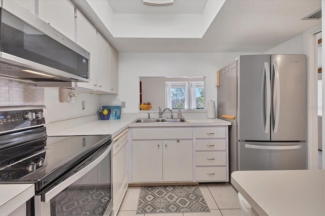 2446 Clubhouse Cir Unit 202, Sarasota, FL 34232 - kitchen with a sink, light tile patterned flooring, light countertops, white cabinets, and appliances with stainless steel finishes
