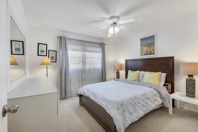 2446 Clubhouse Cir Unit 202, Sarasota, FL 34232 - bedroom with light carpet, a textured ceiling, and a ceiling fan