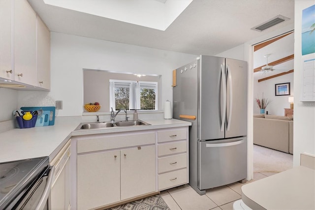 2446 Clubhouse Cir Unit 202, Sarasota, FL 34232 - kitchen featuring stainless steel appliances, light countertops, light tile patterned floors, white cabinetry, and a ceiling fan
