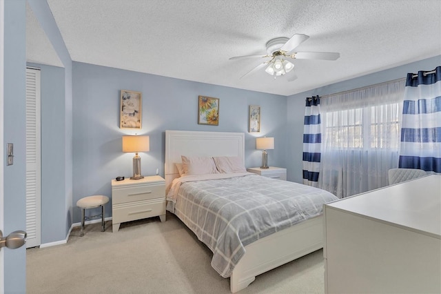 2446 Clubhouse Cir Unit 202, Sarasota, FL 34232 - bedroom with light colored carpet, a ceiling fan, and a textured ceiling