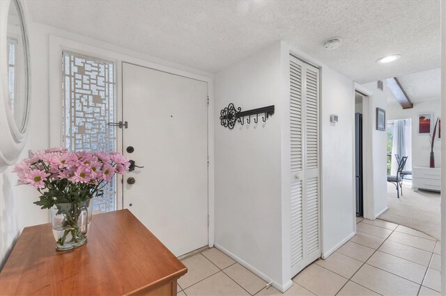 2446 Clubhouse Cir Unit 202, Sarasota, FL 34232 - entryway with light tile patterned flooring and a textured ceiling