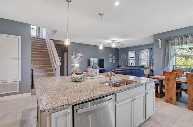 kitchen featuring a center island with sink, visible vents, stainless steel dishwasher, open floor plan, and a sink