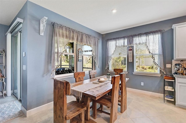 dining room with baseboards and light tile patterned floors