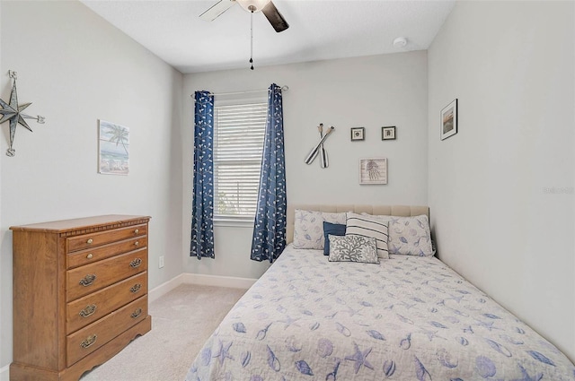 bedroom featuring baseboards, ceiling fan, and light colored carpet