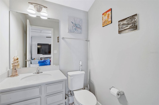 half bath featuring toilet and vanity