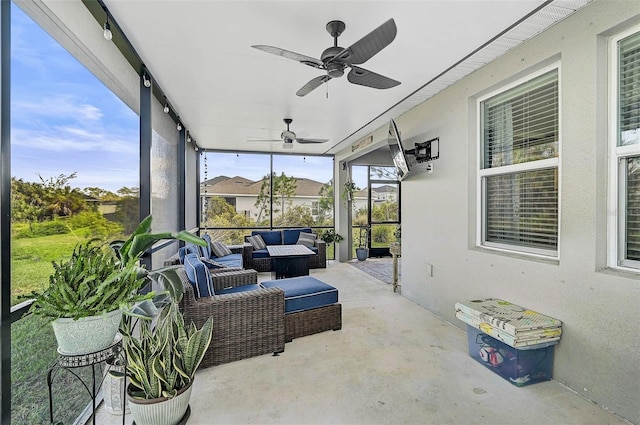 sunroom featuring a ceiling fan