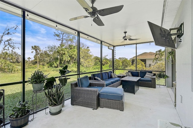 sunroom / solarium with a ceiling fan