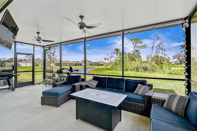 sunroom / solarium featuring a residential view and a ceiling fan