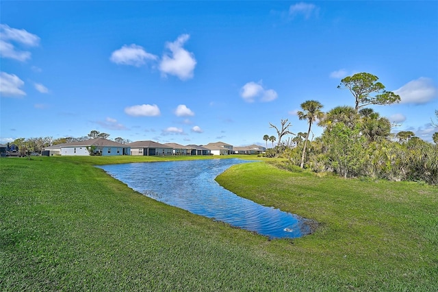 exterior space with a residential view, a water view, and a yard