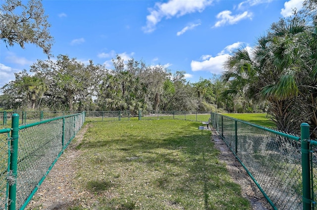 exterior space with fence and a rural view