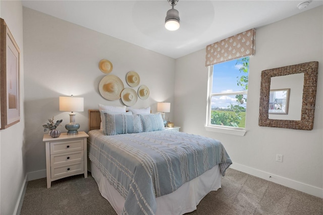 carpeted bedroom with ceiling fan and baseboards