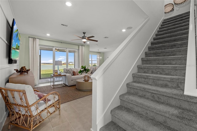 stairs featuring recessed lighting, ceiling fan with notable chandelier, visible vents, and tile patterned floors