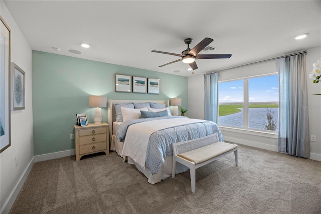 carpeted bedroom featuring recessed lighting, a water view, ceiling fan, and baseboards