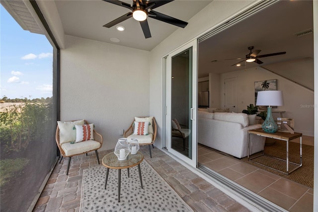 balcony featuring visible vents, a sunroom, and a ceiling fan