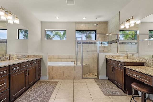 bathroom with a sink, visible vents, a bath, tile patterned floors, and a stall shower