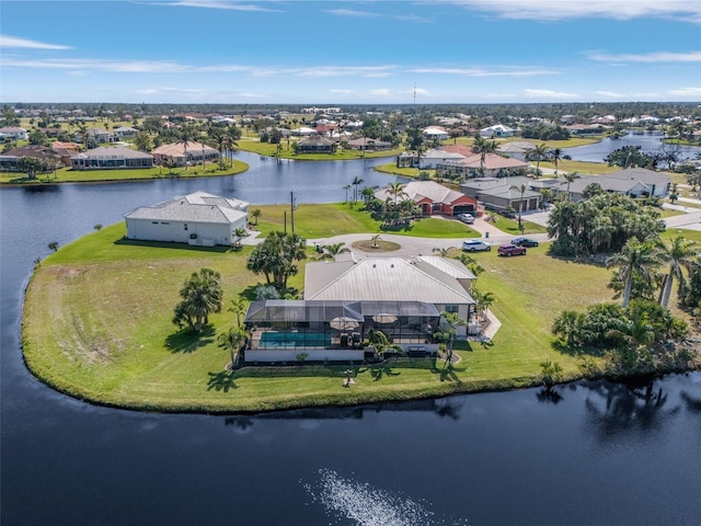 drone / aerial view with a water view and a residential view