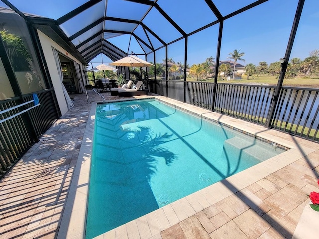 view of swimming pool with a patio area, a lanai, and a fenced in pool