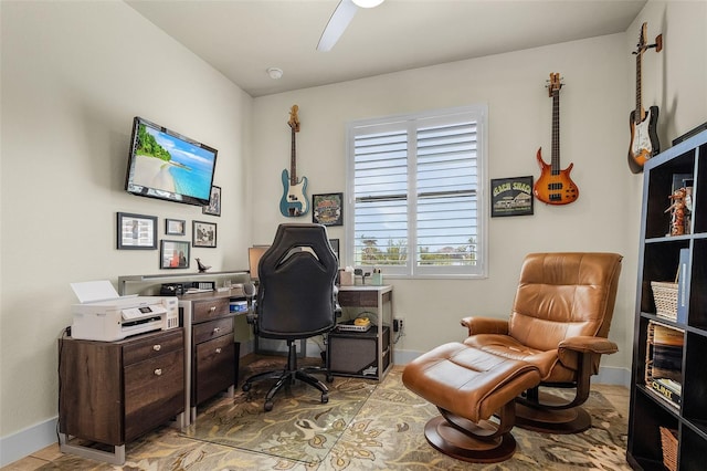 home office with ceiling fan and baseboards