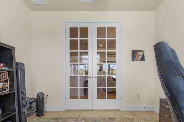 office space with french doors, tile patterned flooring, visible vents, and baseboards