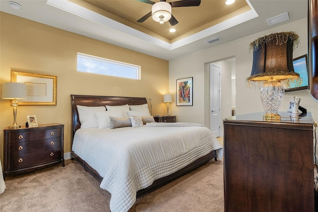 bedroom featuring visible vents, a raised ceiling, carpet flooring, and recessed lighting