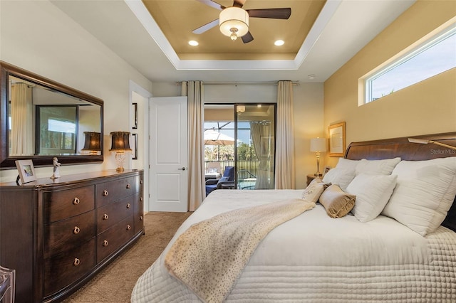 carpeted bedroom with access to exterior, a raised ceiling, and recessed lighting