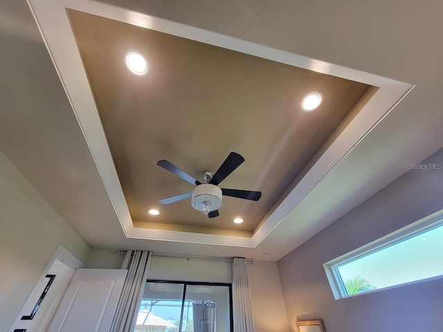 room details featuring ceiling fan, a raised ceiling, and recessed lighting