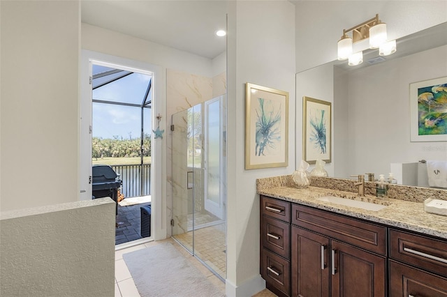 full bathroom with tile patterned flooring, a marble finish shower, and vanity