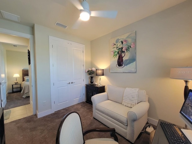 carpeted living room featuring visible vents, ceiling fan, and baseboards