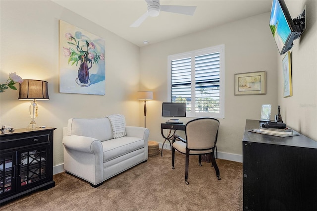 office space with carpet flooring, a ceiling fan, and baseboards